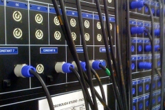 Pairs of numbered Powercon outlets (coloured grey) in the dimmer room carry the output of each dimmer. Two rig sockets can be connected to each dimmer.